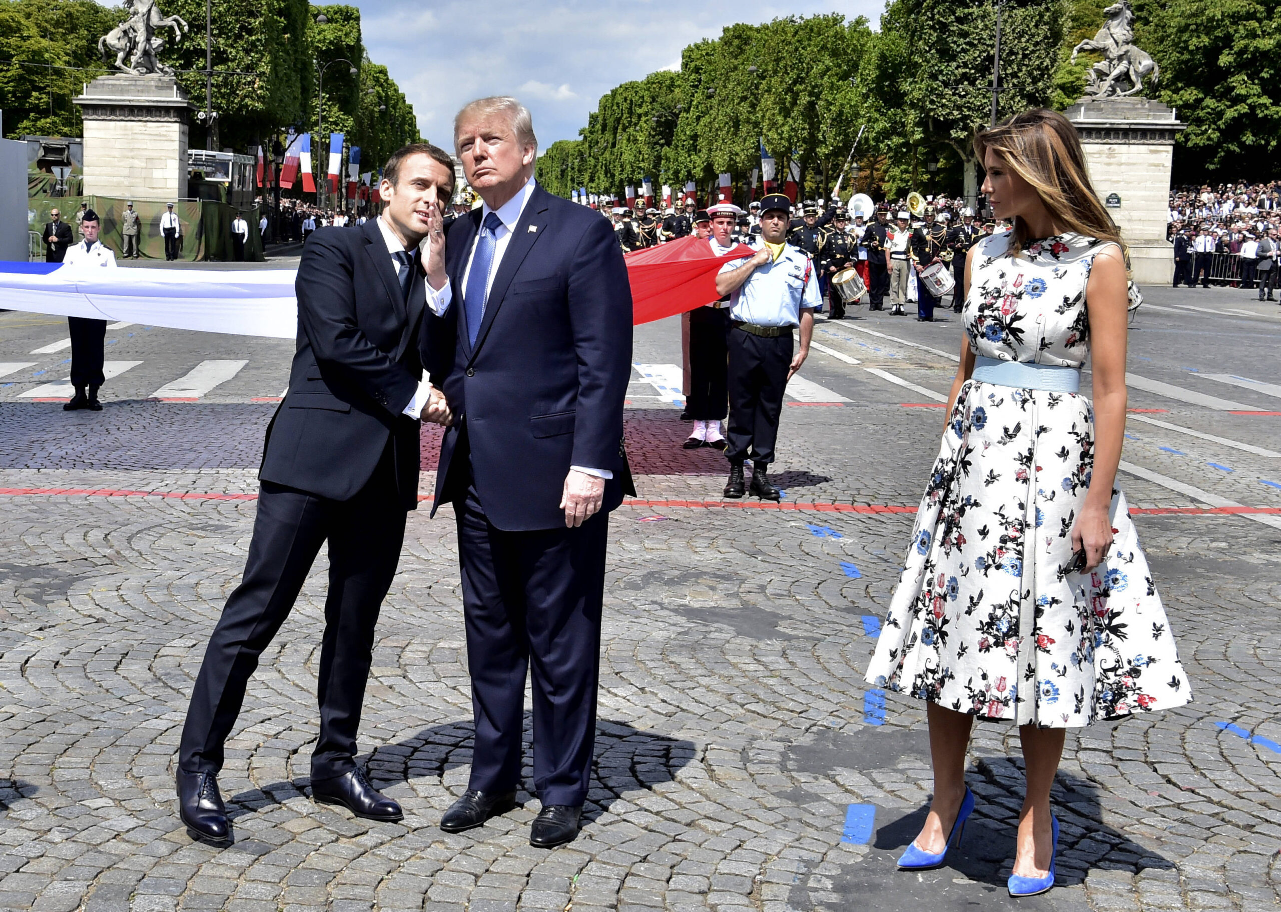 Emmanuel Macron salutes Donald Trump at the end of the 2017 July 14 parade on the Champs-Élysées, under the gaze of Melania Trump. Photo: Carolyn Kaster/AP