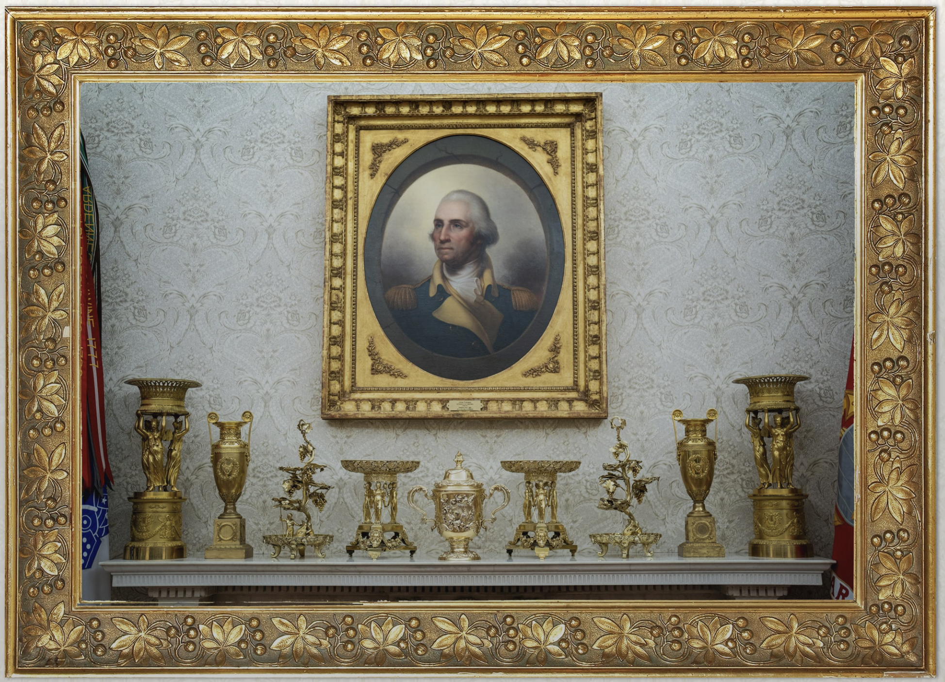 The row of gilded objects on the Oval Office fireplace mantle, beneath Rembrandt Peale’s portrait of George Washington: candlesticks with cariatids, Empire-style vases, bowls and busts in vermeil and gilded bronze. Image from The Washington Post’s investigation.