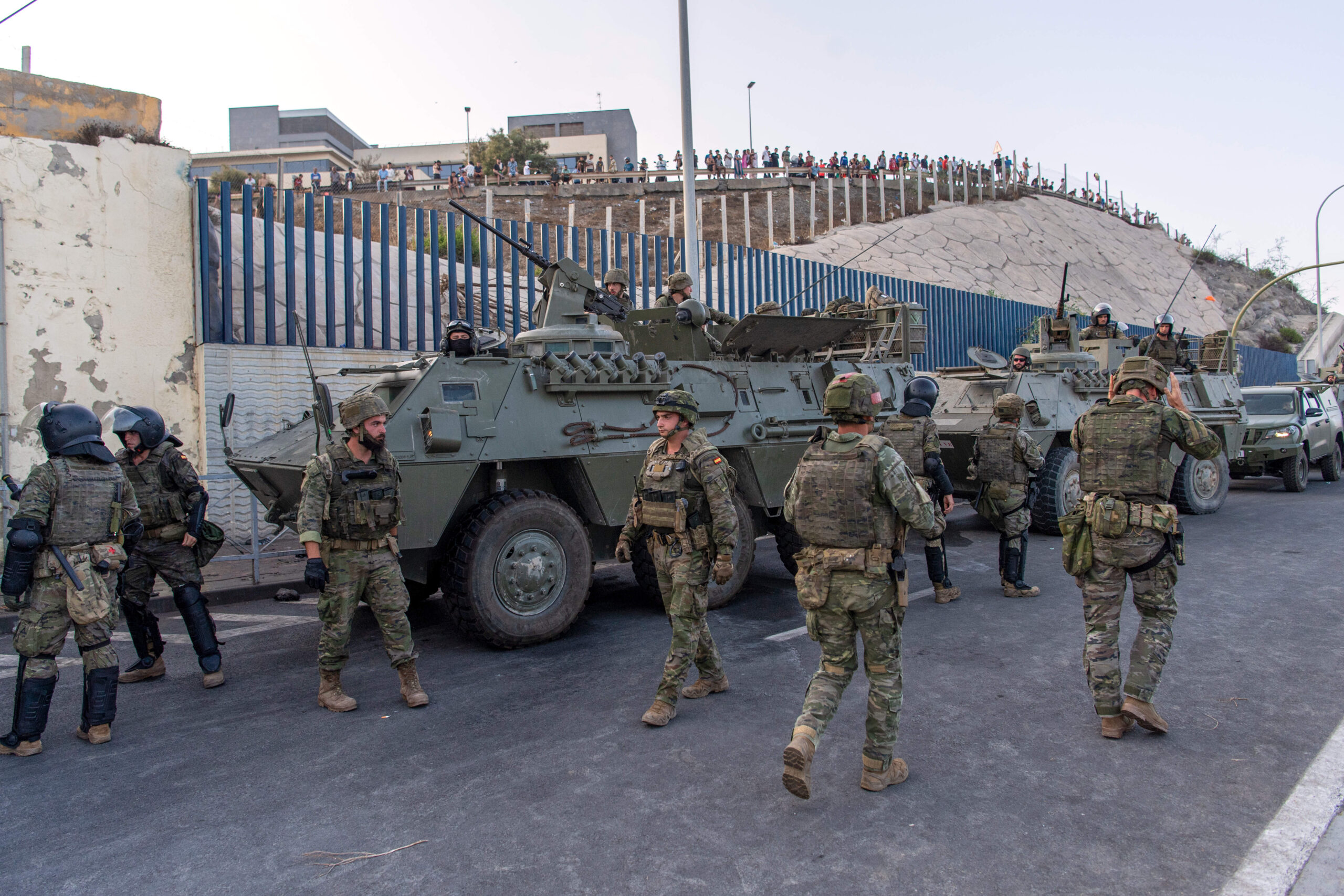 L’armée espagnole et ses blindés se déploient le long de la clôture, jeudi 30 juillet — sous le regard d’une foule massée côté marocain. © AP Photo/Antonio Sempere/SIPA