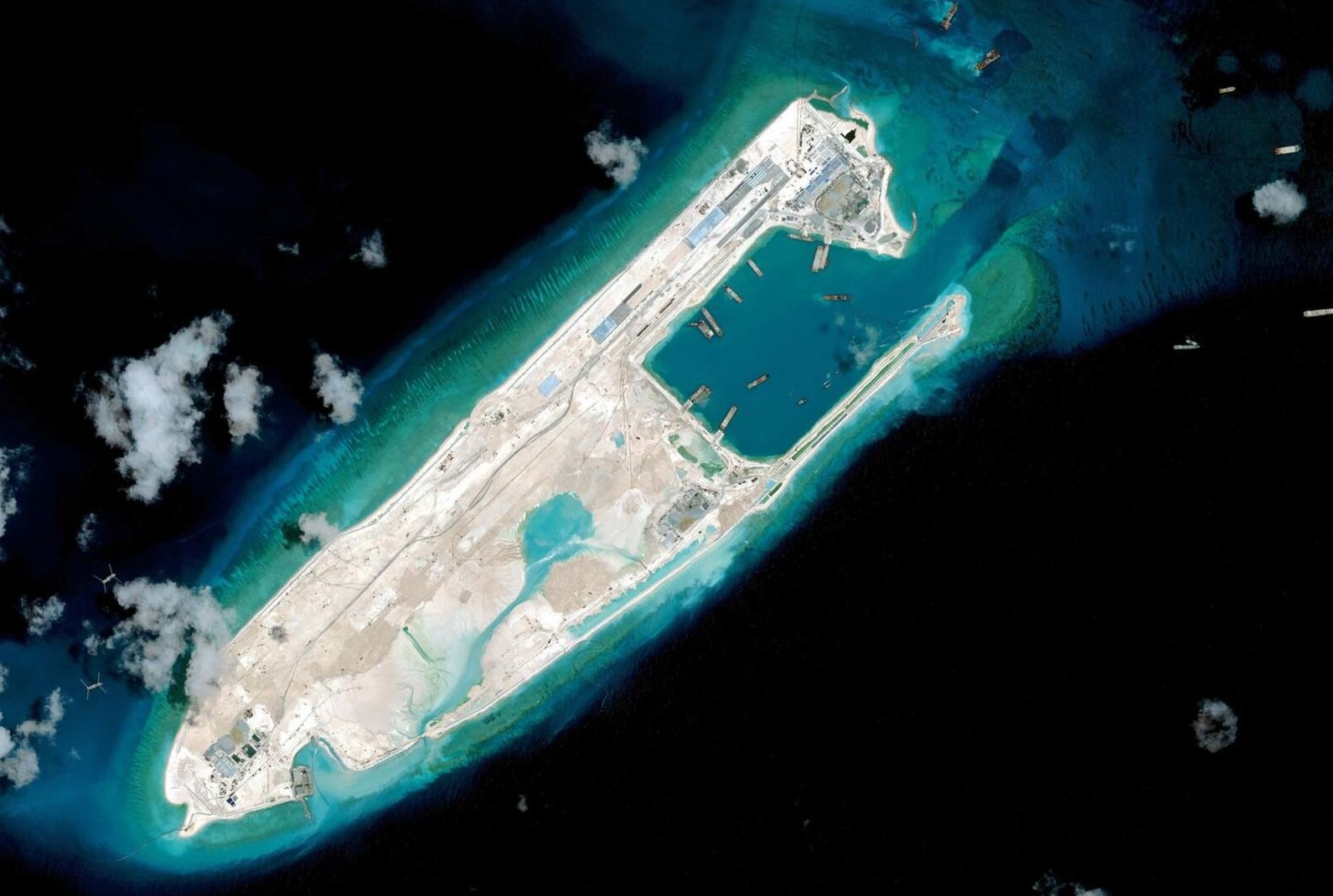 The same reef seen from space on April 17, 2015: within months, Chinese dredging has gained a three-kilometer-long island from the sea, equipped with a runway and a port.