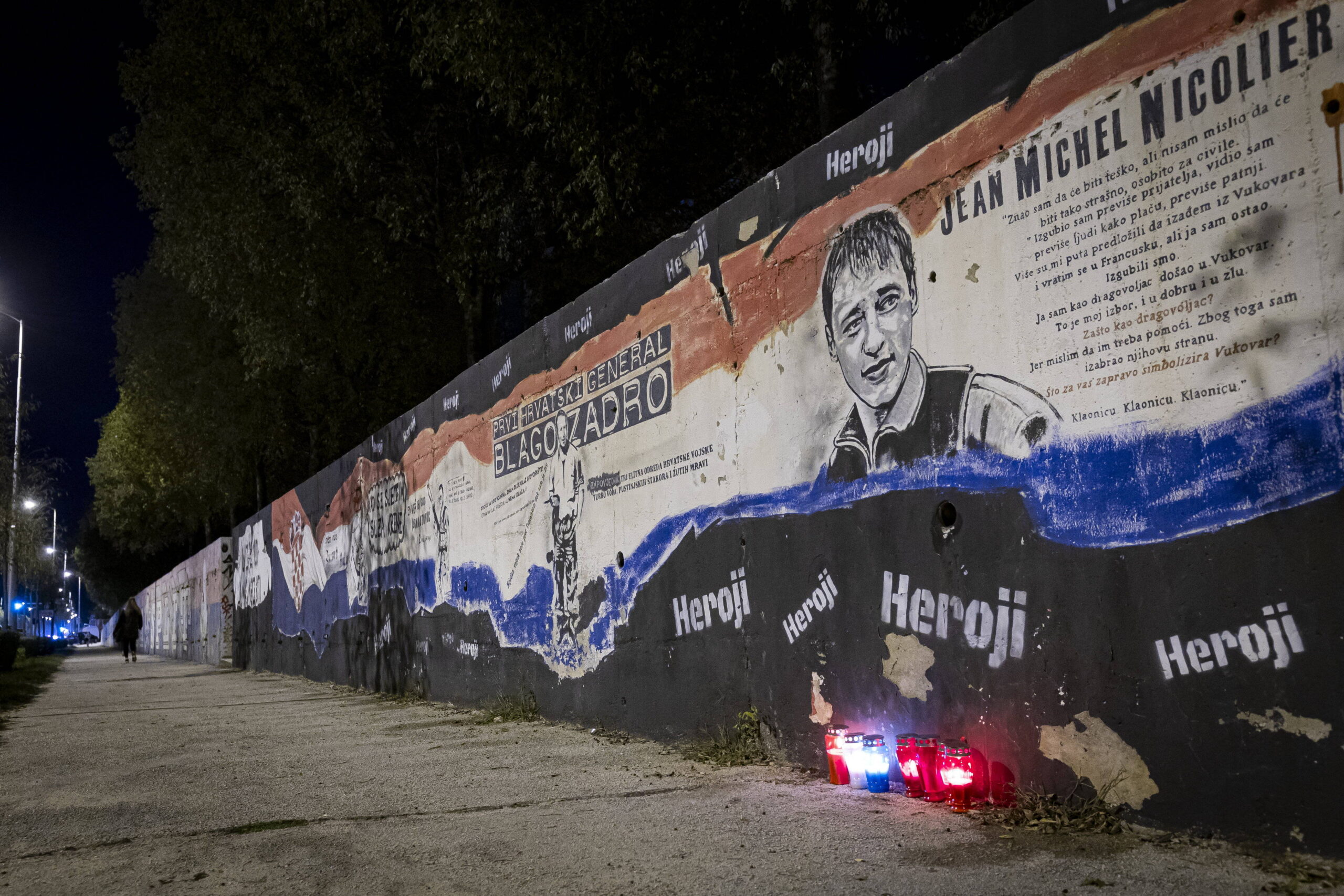 Candles lit in front of a mural honoring Jean-Michel Nicolier, Vukovarska street, Split, Croatia.
