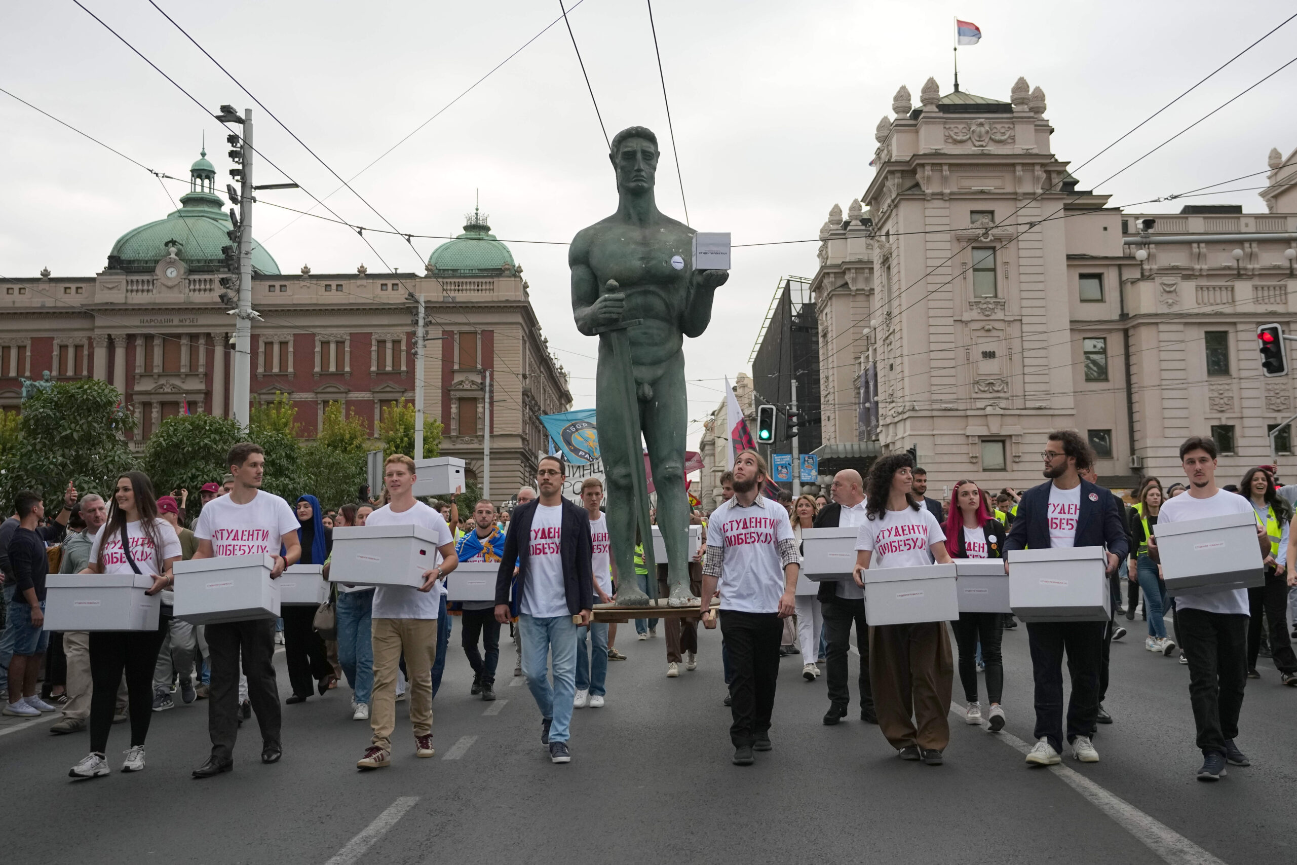 Students carry a replica of the 'Victor', Belgrade's emblematic statue, as they head to the Electoral Commission to submit the signatures of their list to participate in the upcoming parliamentary elections. ©AP/Darko Vojinovic